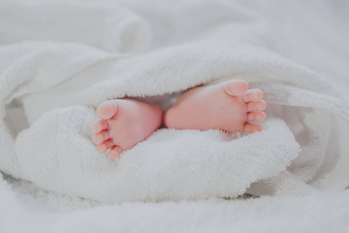 Newborn baby sleeping in a swaddle